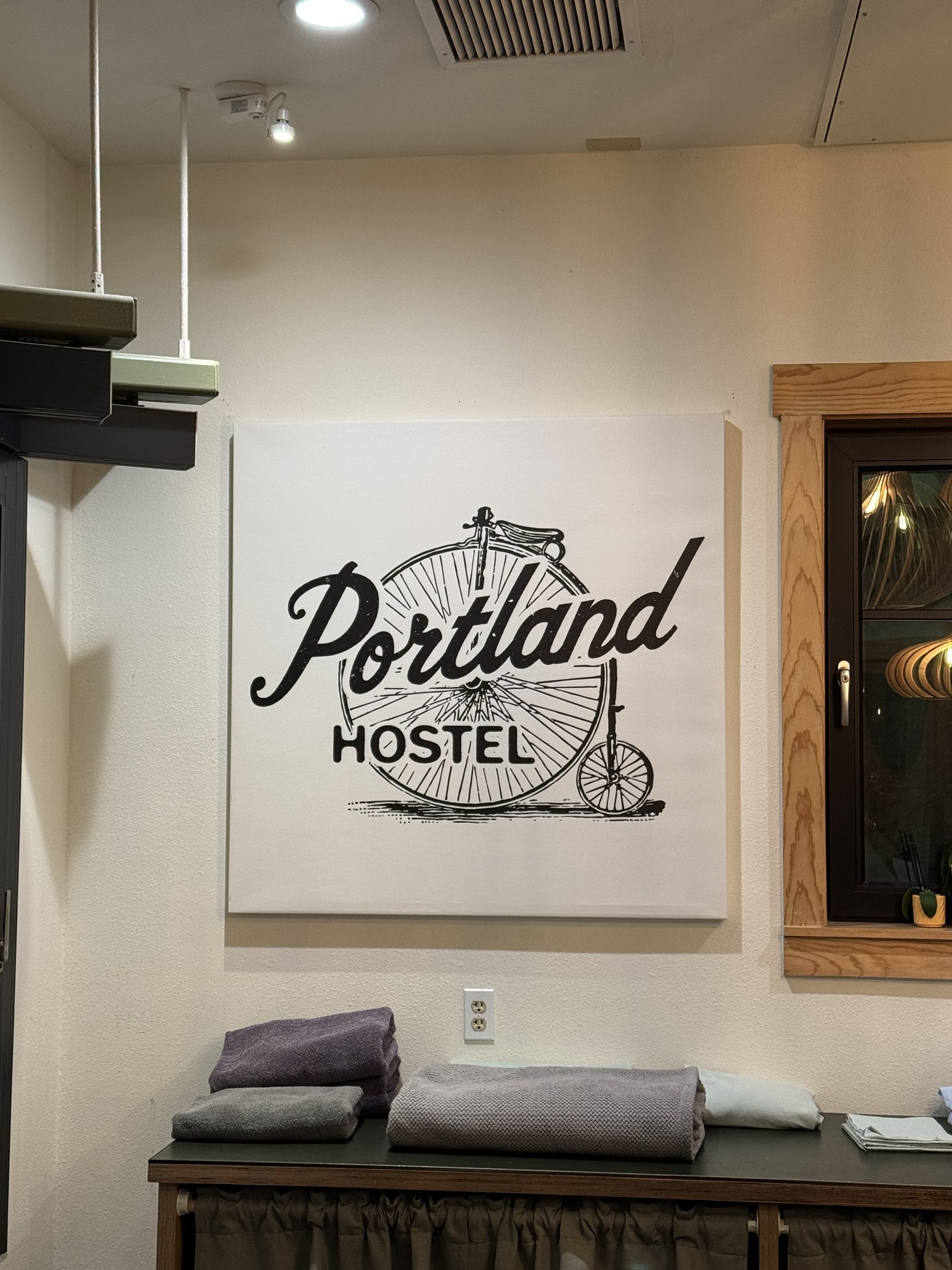 A Portland hostel sign with a bicycle illustration